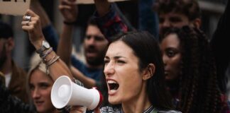Woman with megaphone shouting at a protest