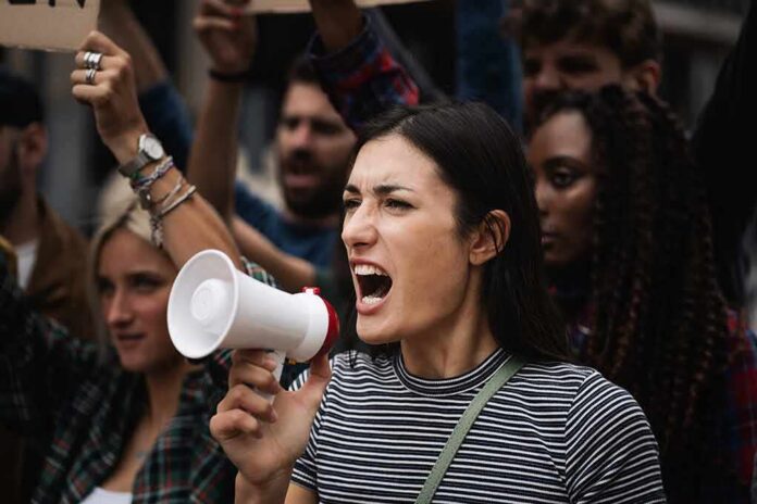 Woman with megaphone shouting at a protest