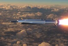 A New Hypersonic Weapon Is Heading To The Fleet Hypersonic missile flying above clouds with bright exhaust flame