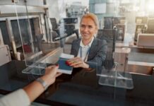 Biometric Dragnet Nails Passport Swappers airport check-in agent handing back a passport
