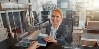 airport check-in agent handing back a passport