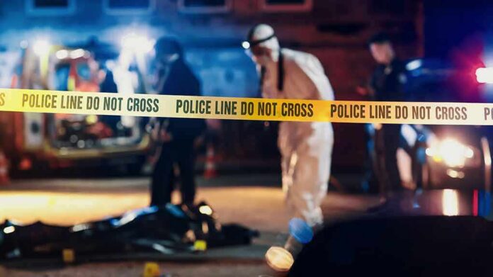 shutterstock_2230644519 Police tape at nighttime crime scene