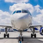 Commercial airplane on runway, front view