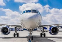 Smoke Column Exposes Air Defense Gaps Commercial airplane on runway, front view