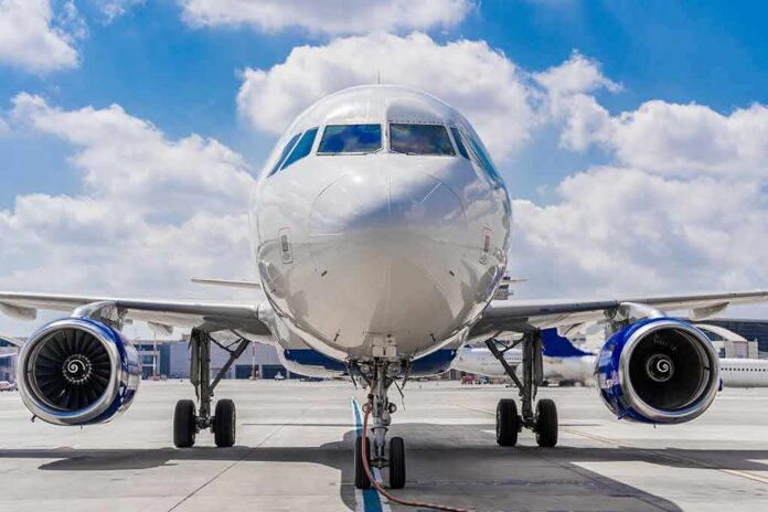 Commercial airplane on runway, front view