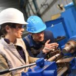 Weeks From Proposing — Both Shot Dead Two workers operating a metal lathe in a workshop
