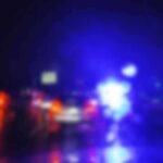 Police lights on a wet road at night
