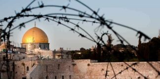 Dome of the Rock and Western Wall framed by barbed wire