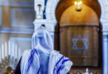 Holy Day Chaos: Shots Rattle Worshippers Person in white and blue prayer shawl facing ornate interior