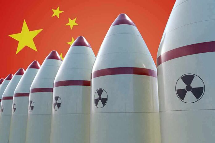 shutterstock_725886730 Row of nuclear missiles with radiation symbols before a red flag with yellow stars