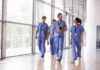 Kia Nurse walking with fellow medical staff in hospital corridor