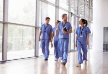 Kia Nurse walking with fellow medical staff in hospital corridor