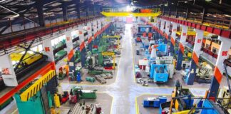 Aerial view of a large industrial workshop filled with various machinery and equipment