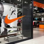 Nike retail store entrance with window display and mannequins