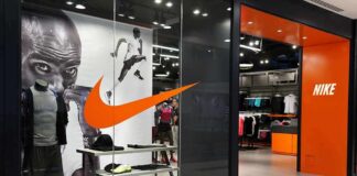 Nike retail store entrance with window display and mannequins