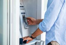 Person using an ATM with a bank card