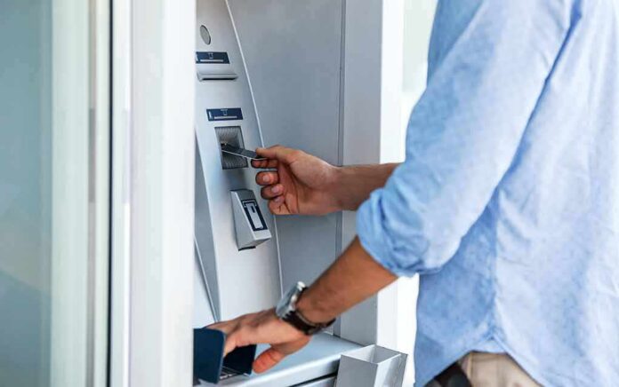 Person using an ATM with a bank card