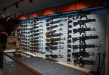 25 States Ask Supreme Court to Take Gun Case Wall display of rifles in a gun store