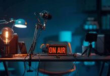 podcast studio desk with on air sign and microphones