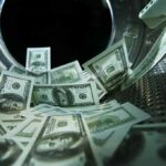 US dollar bills inside a washing machine drum