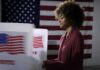 Shock Poll Upends 2028 Chessboard Voter at a polling booth with an American flag backdrop