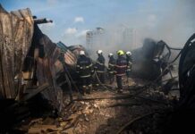 135 Strikes Target Critical Gulf Infrastructure Firefighters amid twisted metal and smoke at a disaster site