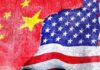 Chinese and American flags torn and overlapping