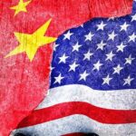 China Just Passed the U.S. in Latin America Chinese and American flags torn and overlapping