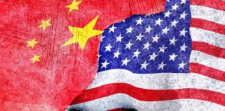 Chinese and American flags torn and overlapping