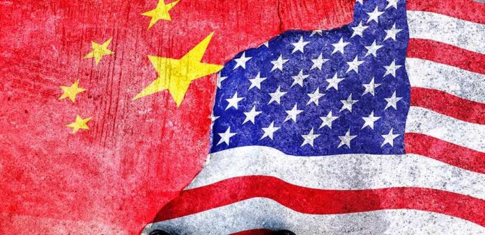 Chinese and American flags torn and overlapping