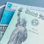 U.S. Treasury check with face mask and hundred-dollar bill