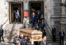 Nine Killed In Shooting At Christian Funeral Pallbearers carry a casket down church steps