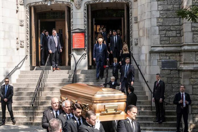 Pallbearers carry a casket down church steps