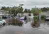 Flooded residential street with partially submerged cars