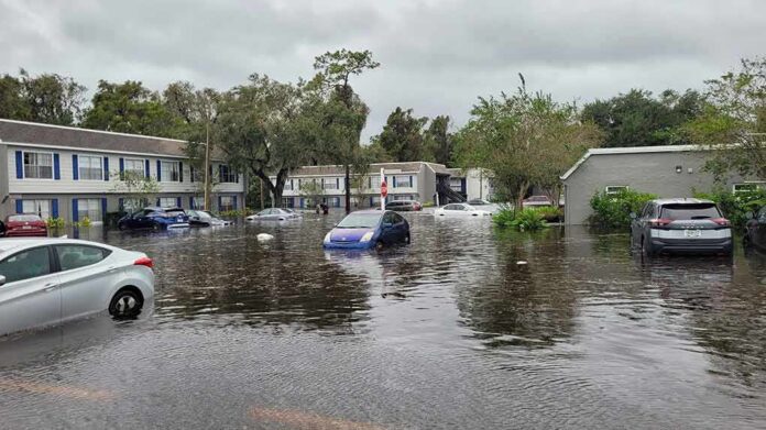 shutterstock_2208210239 Flooded residential street with partially submerged cars