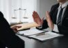 Businessman refusing an envelope at a desk