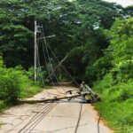 Fallen utility pole blocking a rural road