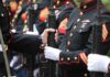 Marines in dress uniforms holding rifles during a ceremony