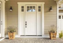 white front door with sidelights and planters