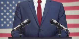 Speaker in suit at podium with microphones