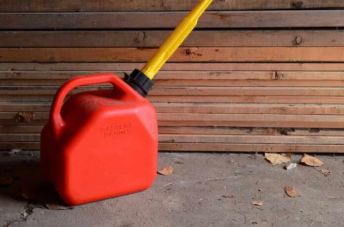 shutterstock_632382434 Red gasoline can with yellow spout on a garage floor