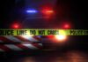 3 Children Killed in Elementary School Shooting Police car behind crime scene tape at night