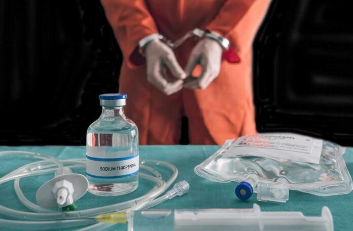 Handcuffed person in orange jumpsuit behind medical vials and IV equipment
